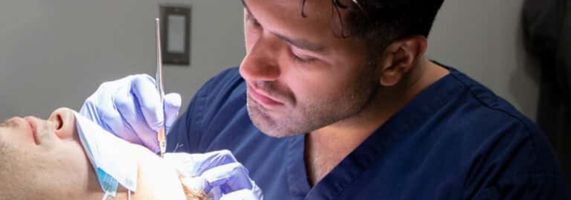Doctor-Sharma-performing-a-hair-transplant-at-the-alberta-hair-institute